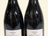 two bottles of wine sitting next to each other on a table