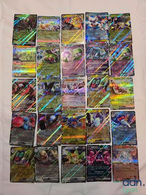 a pile of pokemon cards sitting on top of a table