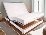 a bed that has a mattress on top of it