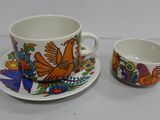 a cup and saucer sitting next to each other on a table