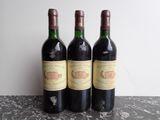 three bottles of wine sitting on top of a table next to each other