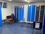 a room with a lot of blue lockers in it