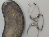 a pair of glasses and a pair of eyeglasses on a table