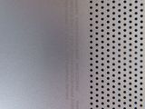 the back side of a silver laptop with a hole in the middle
