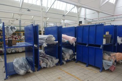 a large room filled with lots of blue bins