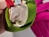 a person holding a small stuffed animal with a tag on it
