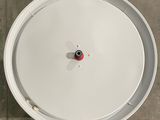 an overhead view of a white drum on a tiled floor