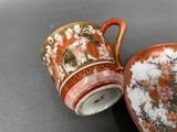 a cup and saucer sitting next to each other on a table