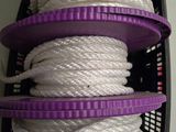 several white ropes are stacked on top of each other in a basket