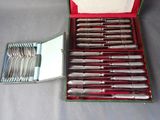 silverware in a red case with a mirror on a table