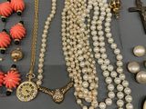 several pieces of jewelry are displayed on a gray surface