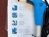 a blue and black blow dryer sitting on top of a box