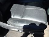 a seat in the back of a car with a seat cushion on it