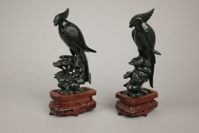 pair of chinese carved jade parrots on a branch
