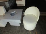 a white chair and a box on the floor