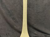 tall yellow vase with a white dot on the top