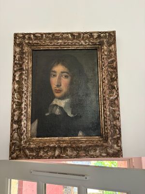 a picture of a painting on the wall above a window