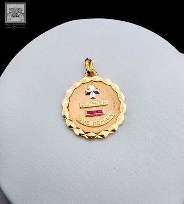 an image of a gold medal with a cross on top of it