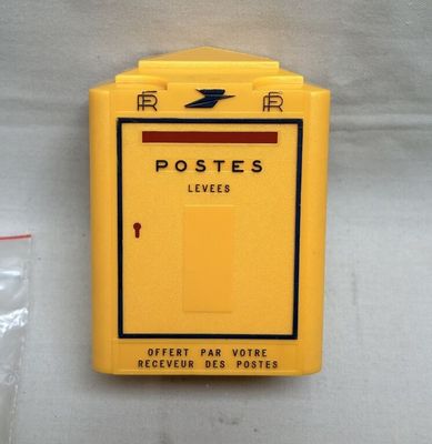 a yellow post box with a red arrow on it