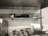 a kitchen with a stove, stove top, and cabinets