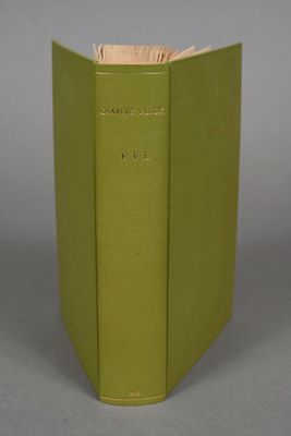 an open book with a green cover sitting on top of a table
