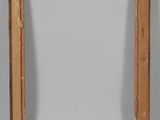 an old wooden picture frame with a white label on it