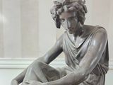 a statue of a woman that is sitting on a table