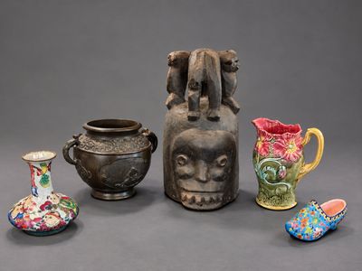 four different vases and a vase with a face on it
