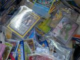 a cardboard box full of pokemon cards and other items