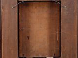 a close up of a wooden frame with a label on it