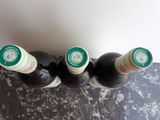 three bottles of wine that are sitting on a table