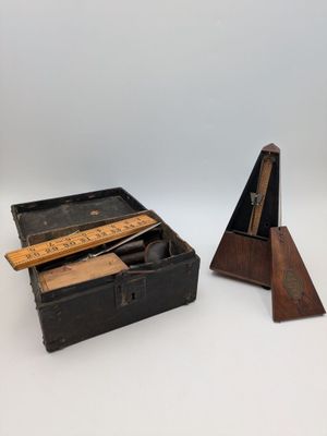 an old wooden box with a ruler and a ruler in it