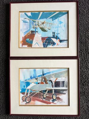 two framed paintings of a plane and a plane on a carpet