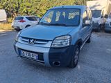 a small blue van parked in a parking lot