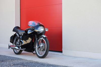 a motorcycle parked in front of a red garage door