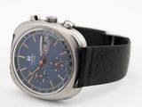 a close up of a watch on a white surface