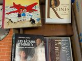 several books are sitting in a cardboard box on a table