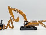 three toy excavators sitting next to each other on a white surface