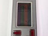 a close up of a small electronic device on a white surface