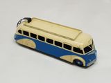 a toy bus that is sitting on a white surface