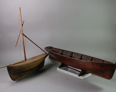 a small boat and a small boat on a stand