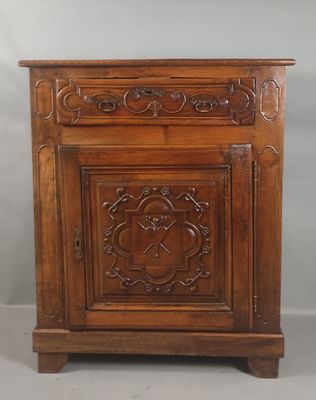 an old wooden cabinet with carvings on the doors and drawers