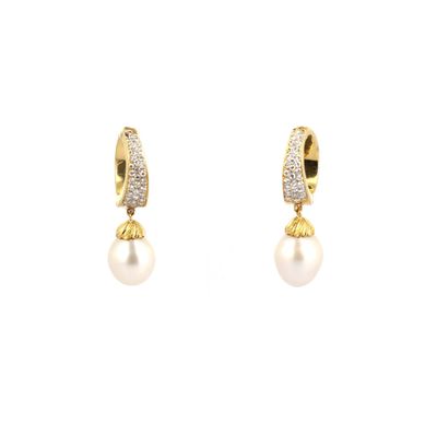 a pair of pearl and diamond earrings on a white background
