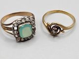 two rings, one with a green stone and the other with diamonds