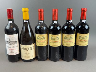 six bottles of wine are lined up in a row on a table