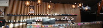 a photo of a coffee shop counter with a lot of bottles