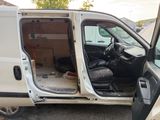 a white van with the door open in a parking lot