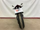 a motorcycle parked in front of a white wall