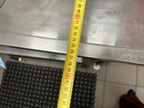 a measuring tape that is on the floor of a kitchen