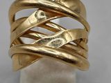 a close up of a gold ring on a marble block